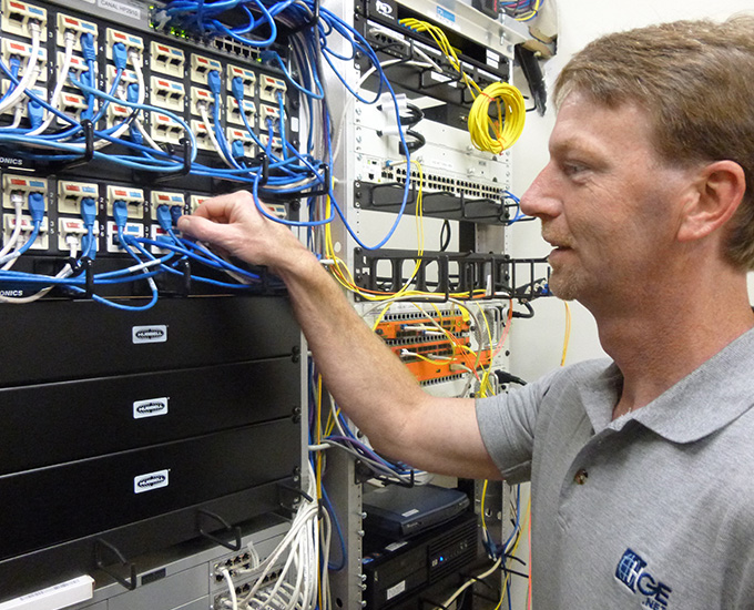 Telecom team member in server room